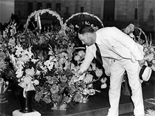 Huey's brother, Earl Long, lays flowers at Huey's gravesite on the Capitol grounds