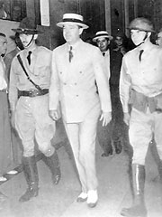 Huey Long surrounded by armed guards in the Louisiana State Capitol