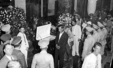 Mourners process by Huey Long's casket lying in state at the Louisiana State Capitol