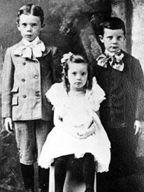 Huey Long as a child (left), with brother Earl and sister Lucille.