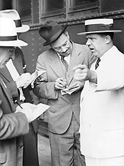 Huey Long speaking with reporters